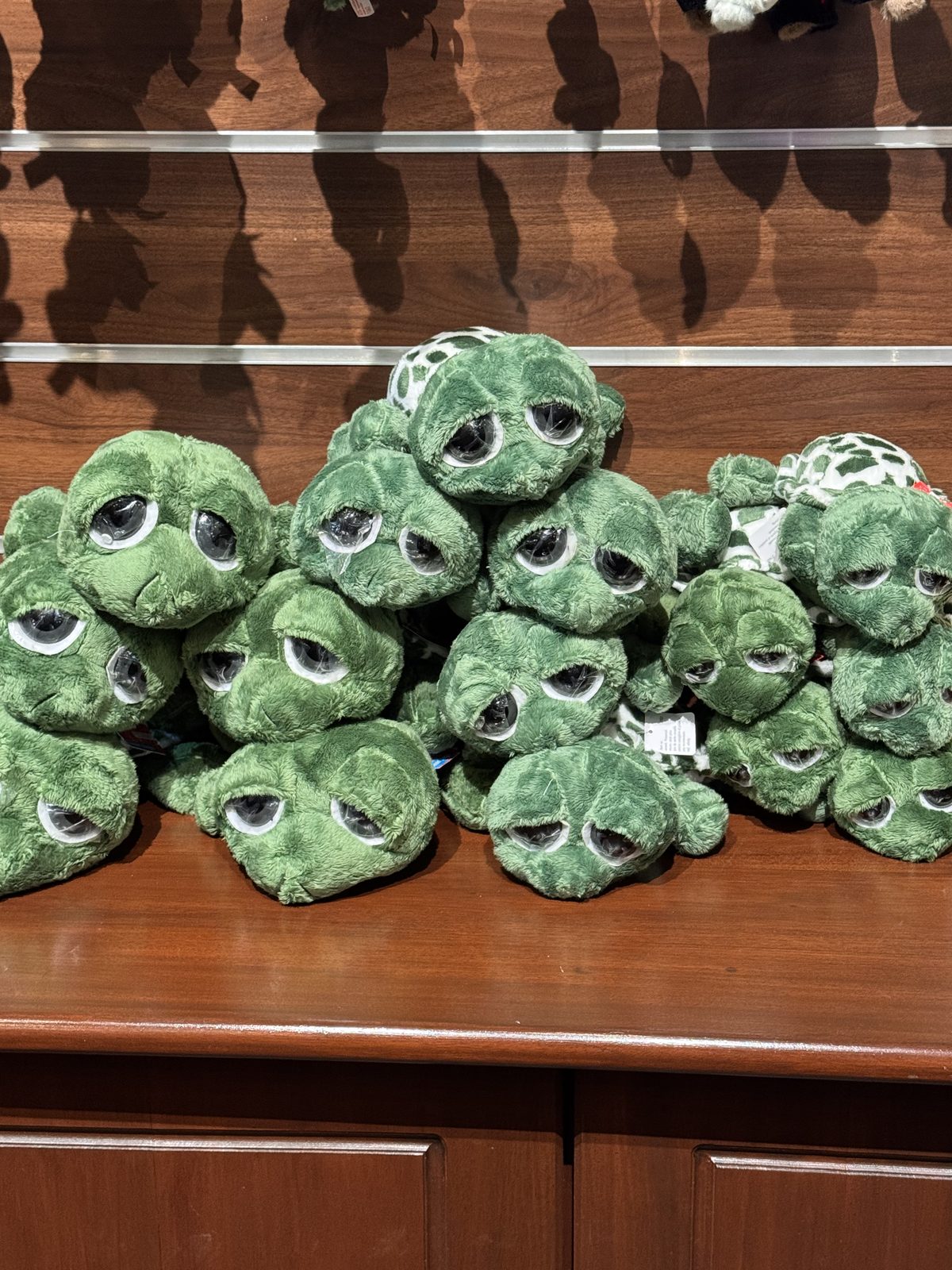 A pile of green turtle plush