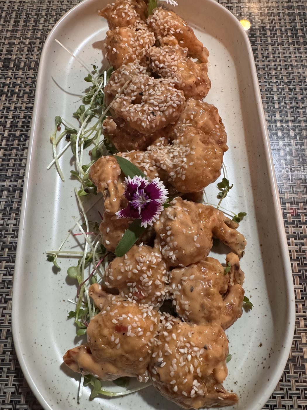 Sesame-crusted fried bites with a flower